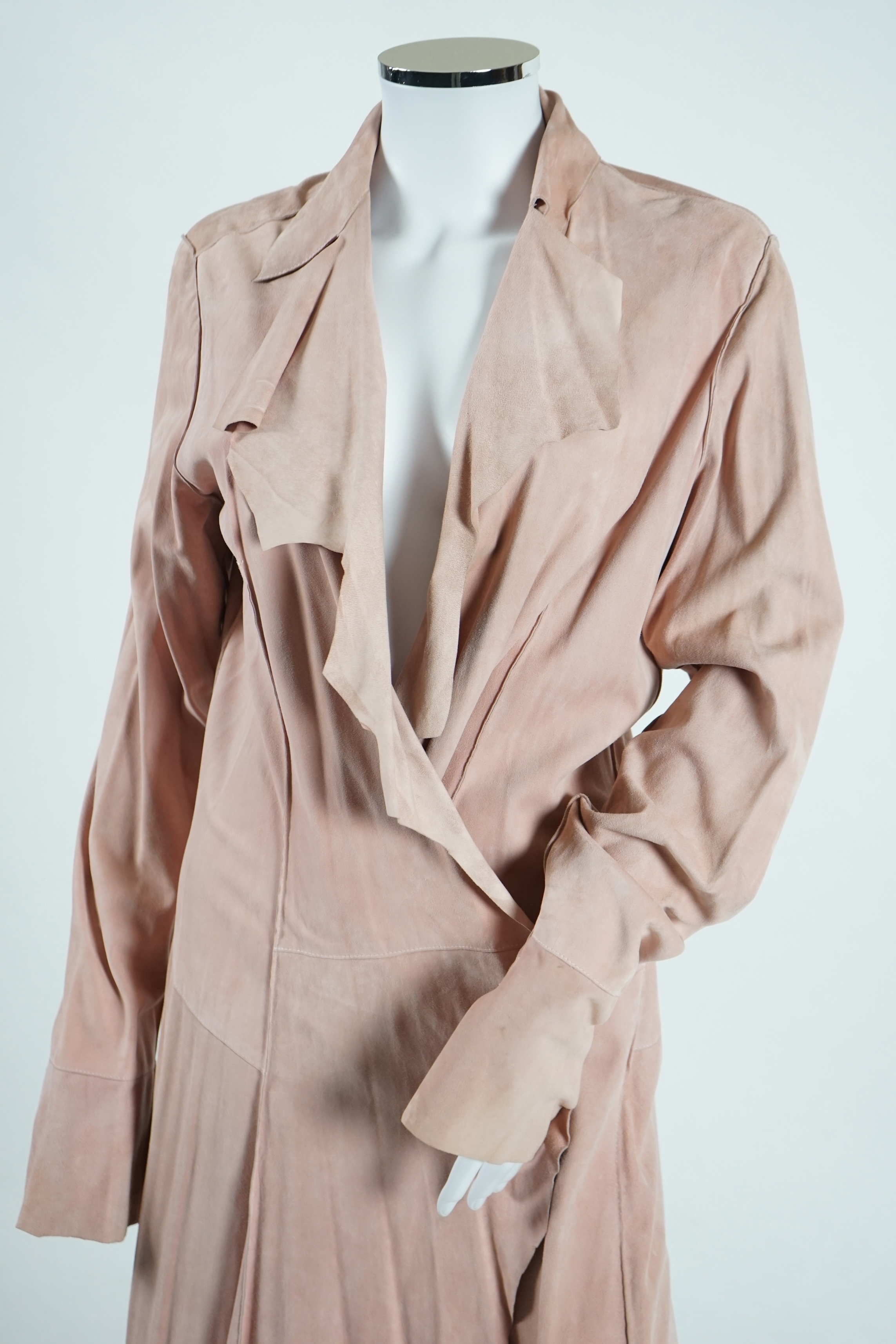 A lady's Angela Caputi silk cream skirt and blouse with fruit design size 46, a Ted Baker white lightweight cardigan with leaf design to the back size 4, a Rawhide dusky pink long laser cut coat size 14 and a Georgina vo